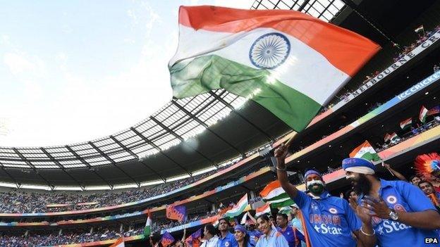 An Indian fan waves a national flag as India plays Bangladesh in the World Cup quarter-final match at the MCG in Melbourne, Australia, 19 March 2015