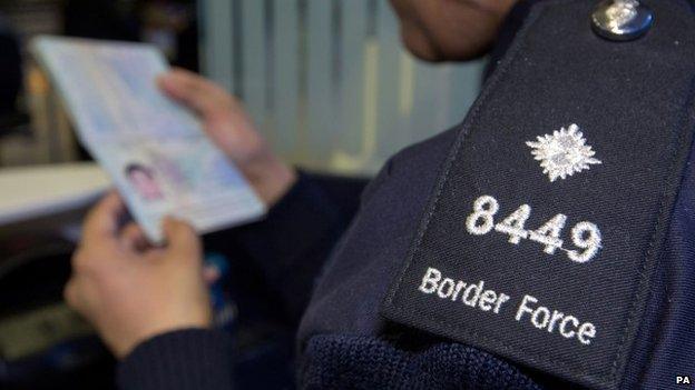 Border Force official checking passport