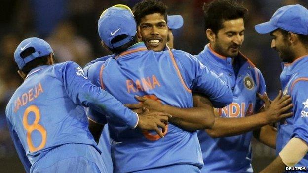 Umesh Yadav (C) hugs Suresh Raina as he celebrates with team mates the fall of the last wicket during their World Cup quarter final win over Bangladesh in Melbourne, March 19, 2015