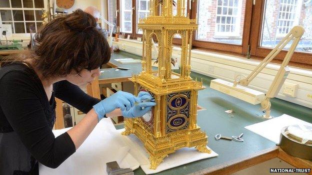 West Dean College staff cleaning the clock