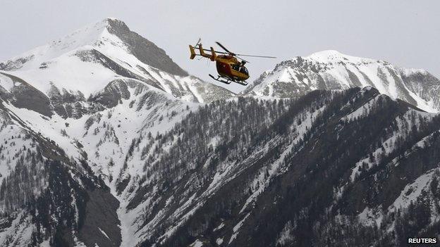 A rescue helicopter from the French Securite Civile flies over the French Alps during a rescue operation after the crash of an Airbus A320, near Seyne-les-Alpes, 24 March 2015