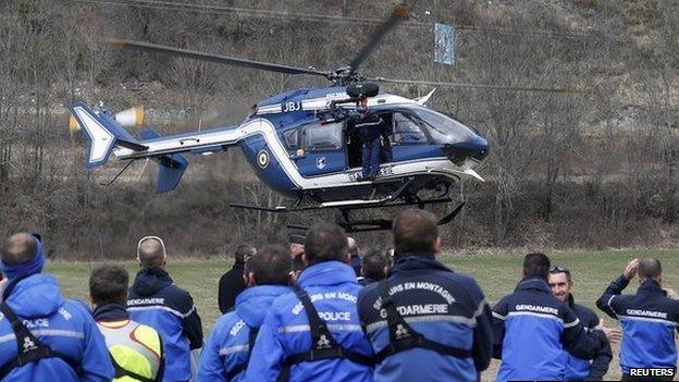 French police and Gendarmerie Alpine rescue units gather on a field as they prepare to reach the crash site of an Airbus A320, near Seyne-les-Alpes, in the French Alps, 24 March 2015