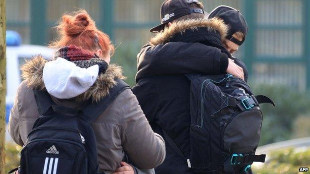 Students comfort each other at the Joseph-Koenig secondary school in Haltern, western Germany on 24 March 2015