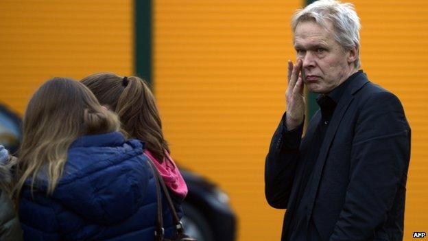 School Principal Ulrich Wessel grieves with students in front of the Joseph-Koenig secondary school in Haltern am See, western Germany on 24 March 2014