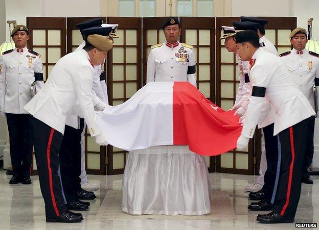 The Guard of honour drapes Singapore's national flag over the coffin of the late first prime minister Lee Kuan Yew