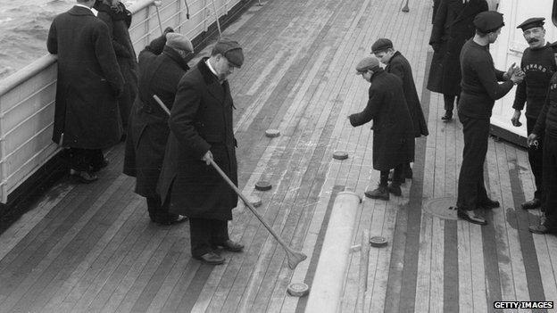 Saloon passengers enjoy a game of shuffleboard on the deck