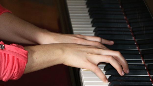 Teenager playing piano