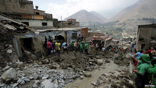 People remove mud and rocks after a massive landslide in Chosica 24/03/15