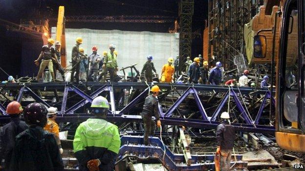 A picture made available on 26 March 2015 shows rescue helpers clean up after a scaffolding collapsed in an economic zone in central Vietnam on 25 March 2015