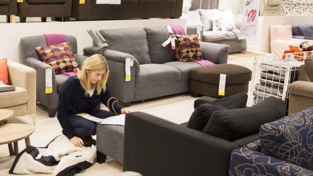 Woman shopping for sofa in IKEA, Wembley, London