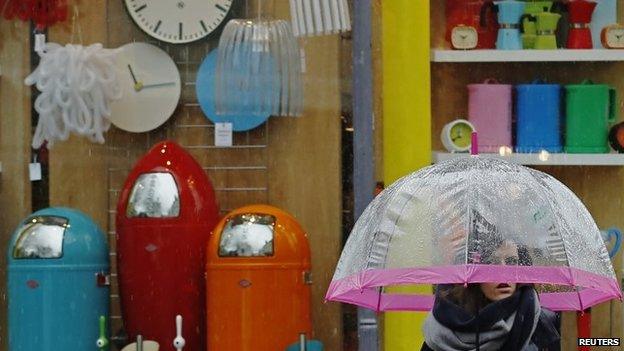 Woman passes household goods shop in Brighton