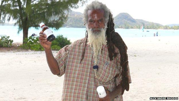 Sylvester Tyrone "Amu" Motley holds up some of his herbal remedies