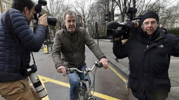 Jeremy Clarkson leaves his home in west London on a bike, followed by photographers