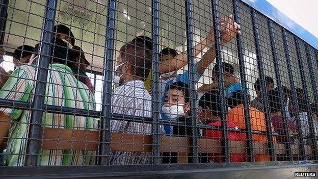 Suspected Uighurs are transported to a detention facility in the town of Songkhla in southern Thailand