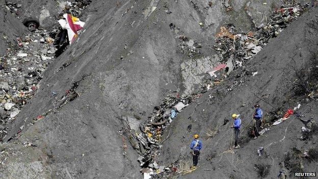 French gendarmes and investigators work amongst the debris of the Airbus A320 at the site of the crash, near Seyne-les-Alpes, French Alps March 26, 2015.