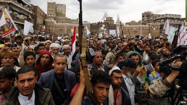 Armed Houthi members hold their guns in the air while shouting anti-Saudi slogans during a rally protesting Saudi-led airstrikes against Houthi positions in Sanaa, Yemen, 26 March 2015