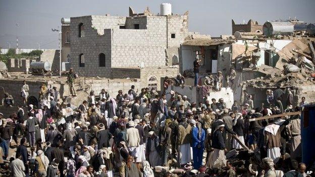 People search for survivors under the rubble of houses destroyed by Saudi airstrikes near Sanaa Airport, Yemen, Thursday, 26 March 2015