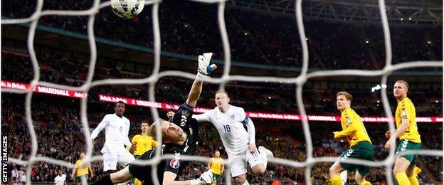 Wayne Rooney scores England's opening goal against Lithuania