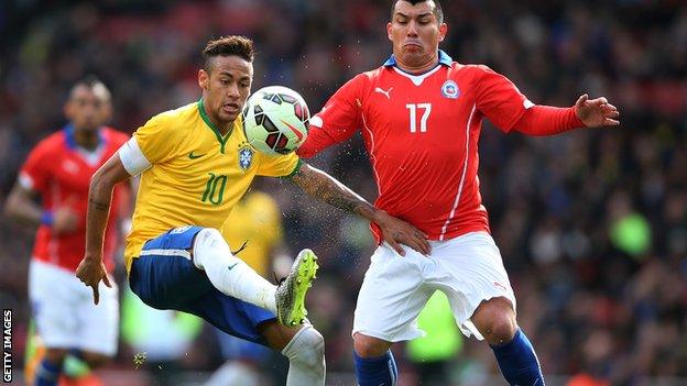 Chile's Gary Medel clashes with Brazil's Neymar at the Emirates Stadium