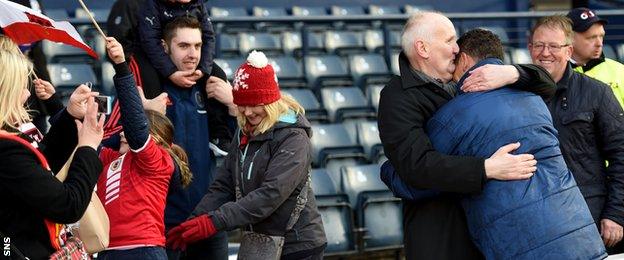 Glasgow-born Gibraltar coach David Wilson gets a hug from his father after the game