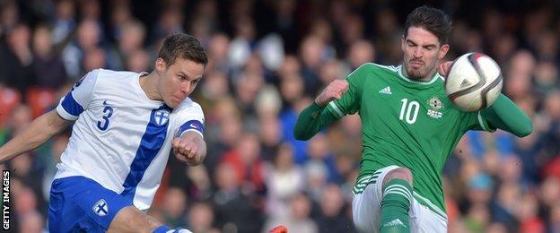 Niklas Moisander attempts to clear the danger as Kyle Lafferty prepares to pounce