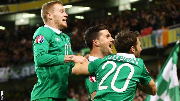 Shan Long celebrates with James McClean and Wes Hoolahan after scoring the Republic of Ireland's equaliser against Poland in Dublin