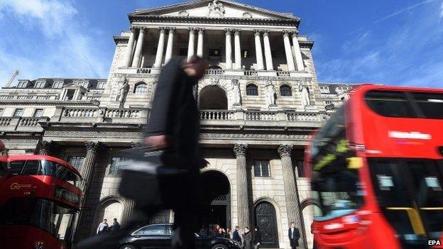 A pedestrian passes the Bank of England in London,