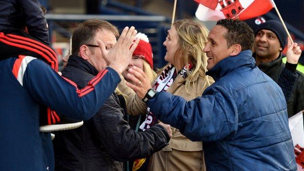 Gibraltar interim head coach David Wilson celebrates with the fans at Hampden