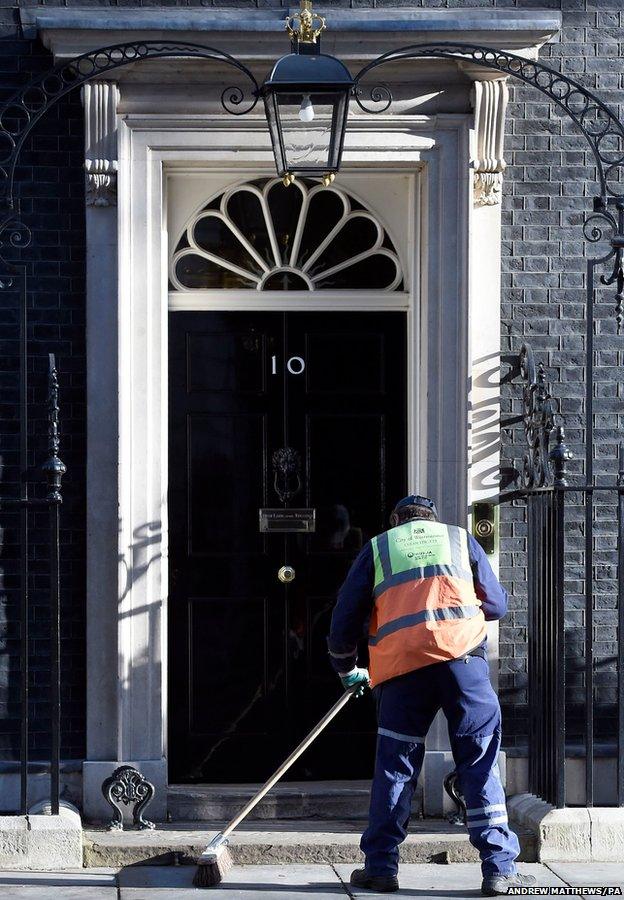 A road sweeper makes his way past 10 Downing Street,