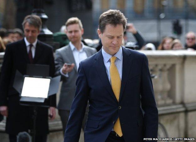 Deputy Prime Minister Nick Clegg walks to the Cabinet Office after speaking to reporters before going to Buckingham Palace