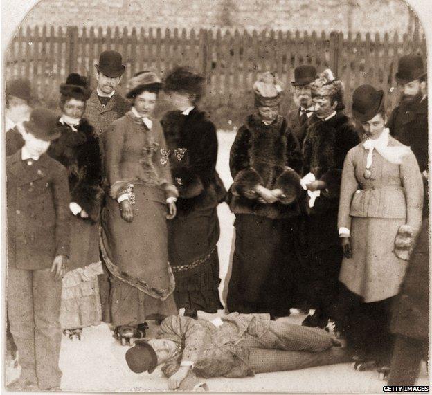 1876: People gather round a fallen rollerskater, who appears more amused than hurt