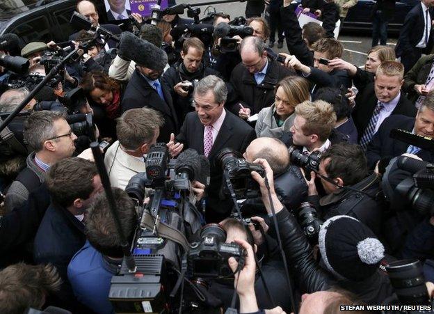 Nigel Farage surrounded by journalists