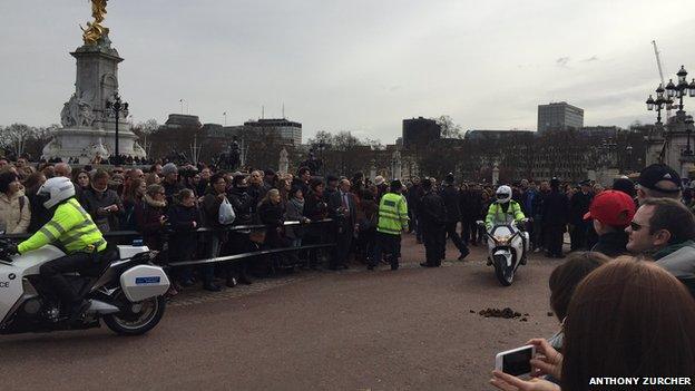 Crowds of citizens, tourists and press wait outside the palace to see David Cameron arrive with a motorcade