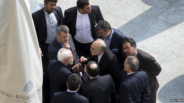 Iran's Foreign Minister Mohammad Javad Zarif and the head of the Atomic Energy Organisation of Iran Ali Akbar Salehi talk outside the Beau-Rivage Palace hotel in Lausanne, Switzerland (19 March 2015)