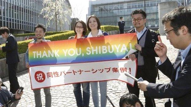 Lesbian activists Hiroko Masuhara (centre L) and her partner Koyuki Higashi (centre R) speak to the media with transgender activist Fumino Sugiyama (L) and gay activist Gon Matsunaka after Tokyo's Shibuya ward recognises same-sex partnerships, outside the Shibuya city hall in Tokyo in this photo taken by Kyodo 31 March 2015