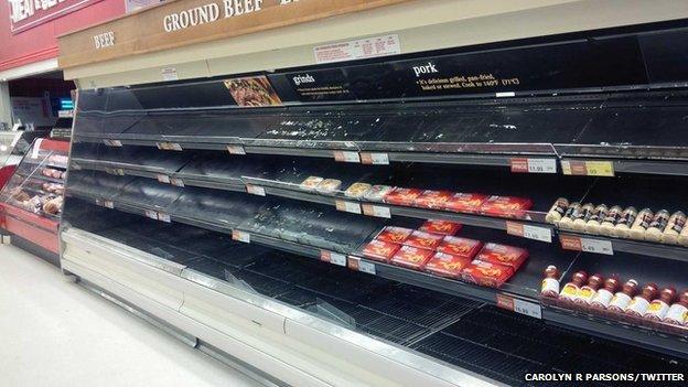 Bare shelves in the meat aisle of a Canadian supermarket