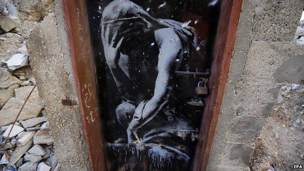 A mural of a crying figure by British street graffiti artist Banksy in the Gaza Strip, 28 February 2015