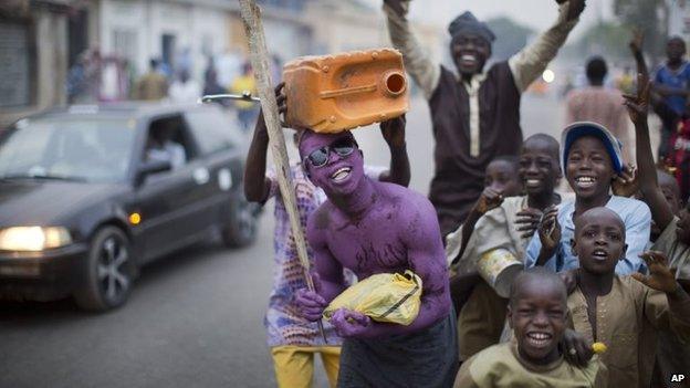 Supporters of opposition candidate Muhammadu Buhari celebrate an anticipated win for their candidate, in Kano, Nigeria Tuesday, 31 March 2015