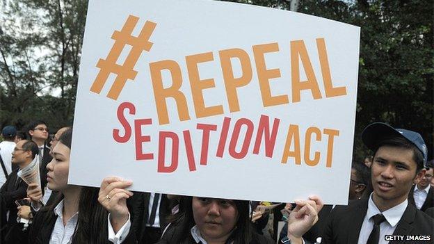 In a photo taken on 16 October 2014, a Malaysian Lawyer holding a placard outside the Parliament house during a rally to repeal the Sedition Act in Kuala Lump