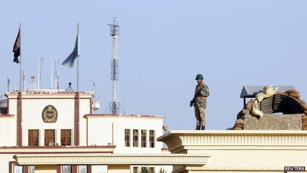 Soldier standing guard outside Almaza military airbase, where a military funeral of security personnel killed in attacks in Sinai is being held, 30 January 2015