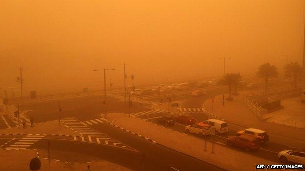 Cars are seen driving amid a sandstorm that engulfed the city of Dubai on 02 April 2015.