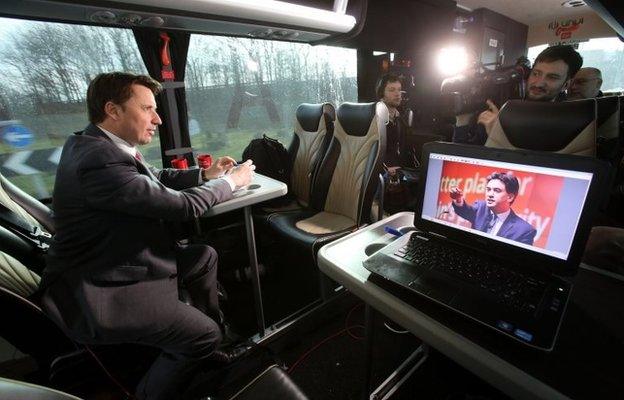 Senior Political correspondent for Sky News Jason Farrell (left) does a piece to camera on board the Labour election bus in Greater Manchester