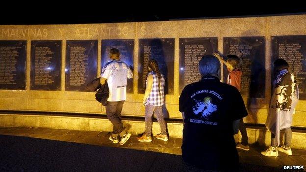 Families visit a memorial in Buenos Aires with the names of Argentine servicemen who died during the 1982 Falklands War on the eve of the anniversary on 2 April 2015