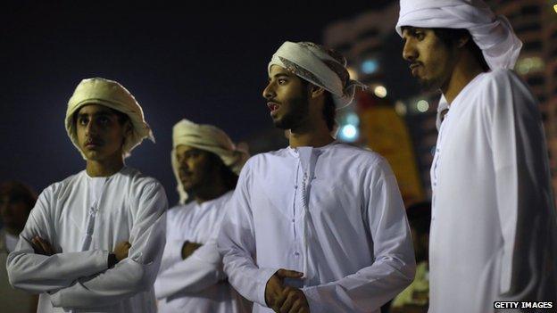 Young men in traditional Emirati dress