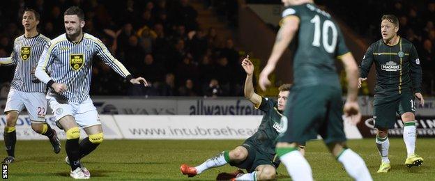 James Forrest (grounded) watches his shot hit the net to give Celtic the lead