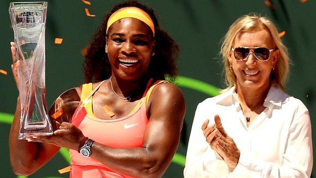 Serena Williams is presented with the Miami trophy by Martina Navratilova