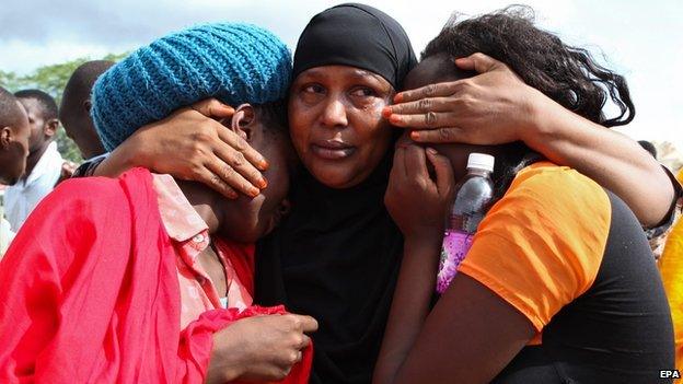 Some of the Garissa University students who were rescued comfort each other at the Garissa military camp on 3 April 2015