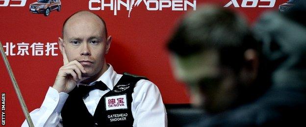 England's Gray Wilson (L) looks on as compatriot Mark Selby plays a shot during the final of the 2015 World Snooker China Open in Beijing