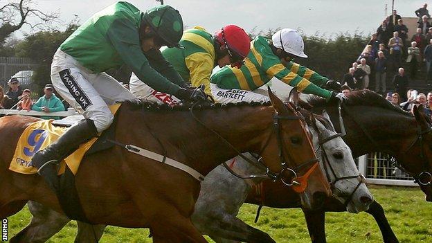 AP McCoy onboard Gilgamboa clears the last with Giitane Du Berlais ridden by Ruby Walsh and Smashing ridden by JJ Burke