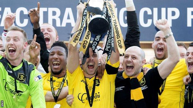 Livingston players celebrate as they lift the Petrofac Training Cup